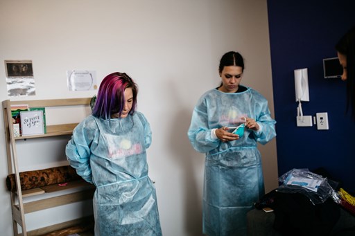 Two woman wearing PPE garments